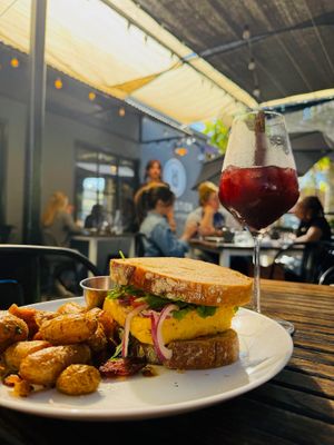 JUST egg Breakfast Sandwich: JUST egg, spicy aioli, tomato, red onion, levain toast, fingerling potatoes (v)(*gf). Brunch hours only. at Revolution Winery and Kitchen in Sacramento