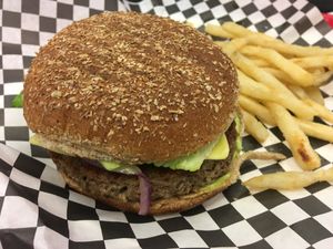 Impossible™️ Burger w/Fries: cheese, lettuce, onion, and avocado spread at Norma's Plant Based Cuisine in Altamonte Springs