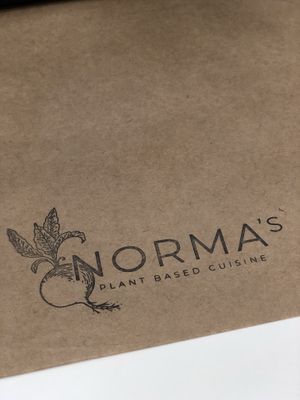 Cute little seating area in book store with paper table runners. at Norma's Plant Based Cuisine in Altamonte Springs