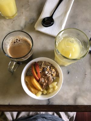 Americano (1.5€), pineapple juice (4€) and chia pudding (4.5€) with peanut butter, fruit and granola as toppings.  at Louvre Michaelense in Sao Miguel