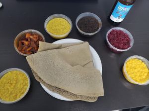 Takeout. Standard order consists of injera with 5 side dishes, I ordered one more. Beer not from Gojo, although they offer beer. at Gojo in Rehovot