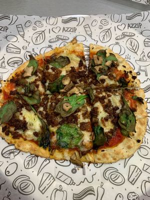 Pizza with the zero sausage, vegan cheese, spinach and mushrooms at Azzip Pizza in Bloomington