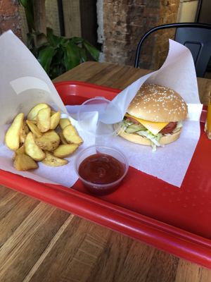 Happy pig burger with potato wedges and ketchup at Complex Burger in Moscow