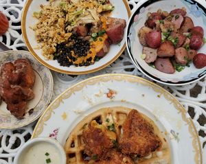 Apple fritters, scrambled tofu plate ( with slaw, potatoes and black lentils), roasted potatoes and sorghum waffles with fried cauliflower and cashew gravy. at Fog Eater Cafe in Mendocino
