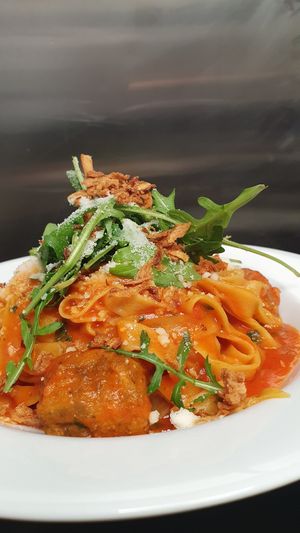Vegan meatballs with homemade tomato sauce,  vegan cheese and crispy onions  at Pasta Factory in Galway