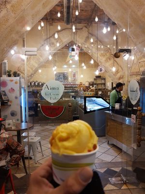 In front of the store with my mango and strawberry delight at Aima Ice Cream in Amman