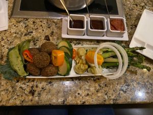 Garden pot; veggie dumplings, vegan “meatballs”, and assortment of veggies  at The Melting Pot in White Plains