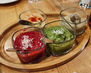 Vegan hummus set: peas, chickpeas, pesto, beetroot. The set includes 5 types of hummus, but the fifth contains milk, ask to make set without non-vegan one. at Herbs & Honey in Gyumri