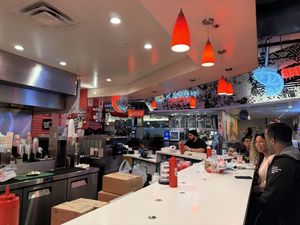 The counter where you eat. There are also shared tables. It’s a loud bustling food court environment shared with other restaurants.   at Monty's Good Burger in Riverside