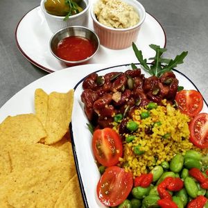 House Salad (vegan):
Smokey Beans, edamame with sesame and orange infused Goji berries, jewelled cous cous. Served with coarse corn chips, olives and chunky hummus at Domu in Bangor
