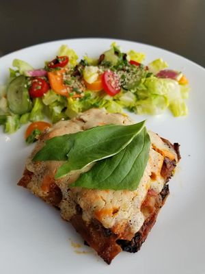 Lasagna with salad at Celest Cafe in Seattle
