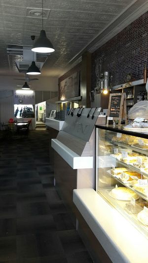Indoors are century-old pressed metal ceiling, 1950s tables and chairs and kitsch wall-panel pictures at Belle Vue Cafe in Warwick