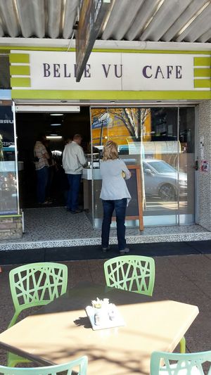Half a dozen footpath tables for wheelchair-friendly and dog-friendly alfresco dining at Belle Vue Cafe in Warwick
