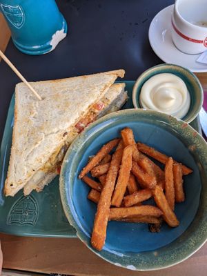 Vegan tripleta (club sandwich) with vegan cheese, soy medaillons, mayonaise, tomato, lettuce, and sweet potato fries on the side at King's Caffe in Malinska