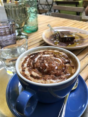 Hot latte with vegan chocolate sauce at My Secret Garden Cafe in Vienna