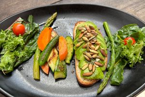 Avocado toast ordered vegan (with extra veggies instead of egg)  at Papaya Playa Project in Playa Del Carmen