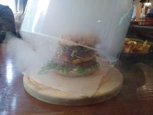 Smoke trapped under glass dome is released when butter is served at The Orange in Fulda