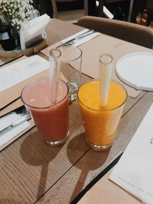 strawberry and banana smoothie, mango and peaches smoothie with glass straws! at Baker and Spice in Kuwait City