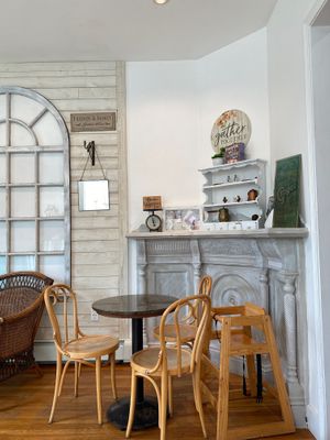 Indoor seating area with a high chair and tchotchkes at Juicygreens in Jamaica Plain