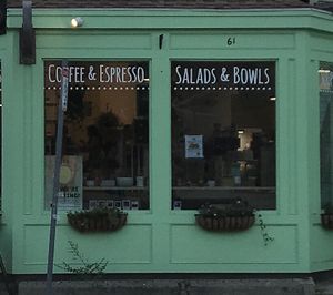 Storefront at night at Juicygreens in Jamaica Plain