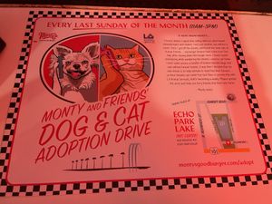 Place mats inside-promoting pet adoption ❤️  at Monty's Good Burger - Koreatown in Los Angeles