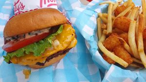 Double cheeseburger with fries + tots at Monty's Good Burger - Koreatown in Los Angeles