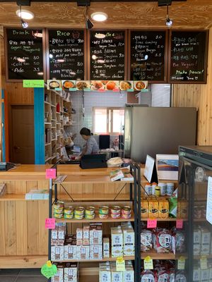 Friendly owner and the menu at Loving Hut in Seogwipo