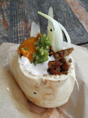 Shawarma in pitta with spicy green pepper, tahini and amba (mango sauce) at Sultana in Tel Aviv