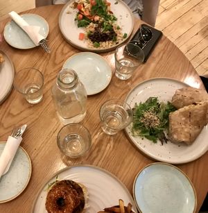 Water on table as standard, tex mex scramble (top), 9 layer burrito (right) bbq burger topped with onion rings (lower) at Fresh Kitchen & Juice Bar in Toronto