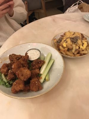 Buffalo cauliflower wings + poutine!!!  at Fresh Kitchen & Juice Bar in Toronto