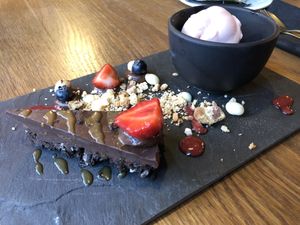 chocolate tarte with crashed orion cookies & orange sorbet - be aware of the decoration: nothing of this was vegan (I asked)!!! Be sure to asked the stuff if you have doubts! at Zeeuwse Streken in Middelburg