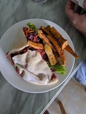 Falafel pita with sweet potato fries at Roots Plant-Based Cafe in Da Nang