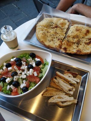 Greek salad with sliced focaccia at Vegrano in Lucca
