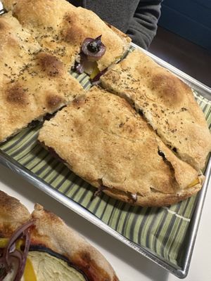 Focaccia with olives, bell pepper, cheese, olives   at Vegrano in Lucca