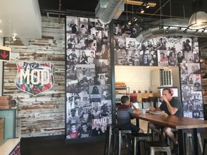 Wall of photos at Mod Pizza - E Ontario in Corona