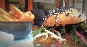 Curry-tofu burger w/ sides.

Tofu marinated in ginger and curry.
Served with brioche bun, pickled onions, mushroom ketchup, basil glace, mix salad, bean sprouts, mayonnaise, cucumber and grated beetroot.

MUMS! at Cafe Blå in Copenhagen