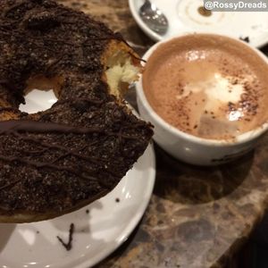 Vegan Oreo doughnut taken away to enjoy with a hot chocolate at DoughNotts in Derby