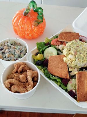 Chicken strips, chickpea dill salad, Greek salad at Golden Dinosaurs in Gulfport