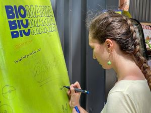Writing happy messages on our Surfboard at BioMania Street Food in Bol