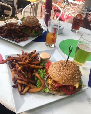 chicken burger and fries with the best garlic sriracha ever at Neue Republik Reger in Berlin