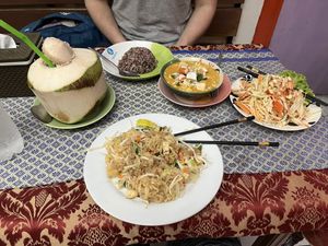 Pad thaï, red curry, papaya salad and fresh coconut   at May Kaidee in Bangkok
