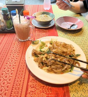 Top: massaman, bottom: pad see ew, drink: thai milk ice tea  at May Kaidee in Bangkok