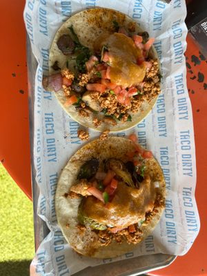 Two corn tacos with tofu “chorizo”, vegan cauliflower queso, and some veggies at Taco Dirty in Tampa