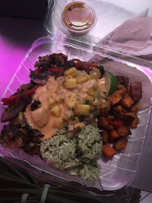 Feel real veggie bowl with sweet potatoes, black beans, guac, guac rice, brussel sprouts, peppers and onions, pineapple salsa, and vegan queso (so good) at Taco Dirty in Tampa