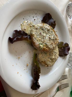 Two vegan croquettes filled with mashed potatoes & vegetables, a bread crumb crust and a soy cream sauce at Trattoria Portixedda in Oristano
