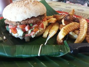 Chickpea burger patty with hummus in vegan bun with chips at Yoddoi Coffee & Tea in Chiang Rai