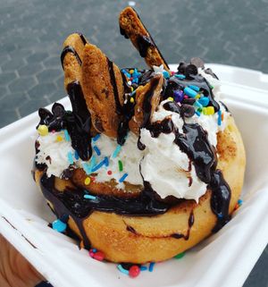 Cookie Party cinnamon bun at Toronto Vegfest 2019...a cinnamon bun with chocolate chip cookies, chocolate sauce, sprinkles, and chocolate chips at Cinnaholic in Thornhill