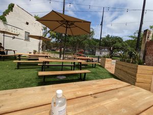 Outdoor picnic table seating at Houston Sauce Co in Houston