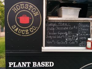 Food truck with menu board at Houston Sauce Co in Houston