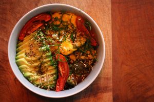 Veggie bowl (VEGAN): A mix of sauteed vegetables (zucchini, broccoli, corn & portobello) with balsamic & pesto, roasted tomatoes, sprinkled with leafy greens, seeds & pesto. *** Add an extra egg or parmesan *** at Inside Cafe in Guanajuato